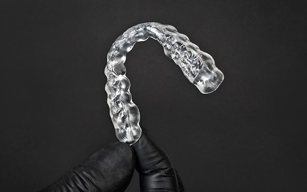 Image shows a highly transparent and polished 3D printed splint using the RS Crystal Polish reservoir