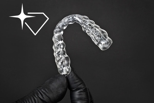 Hand holding a 3D printed dental splint using Rapid Shape Crystal Polish Reservoir for the PRO 30